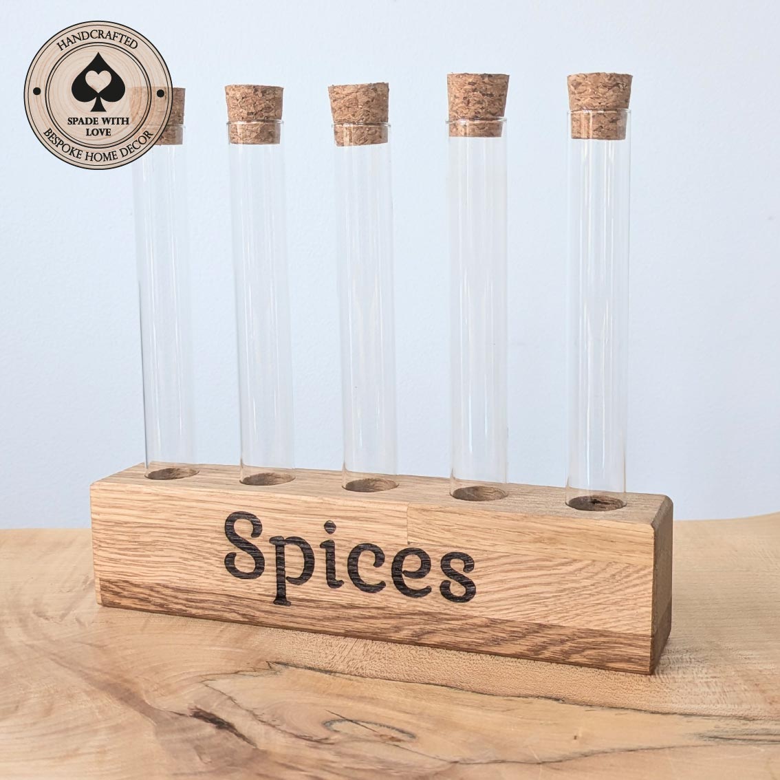Spice rack with glass containers and cork lids on a wooden base, branded 'Handcrafted Spade with Love'.