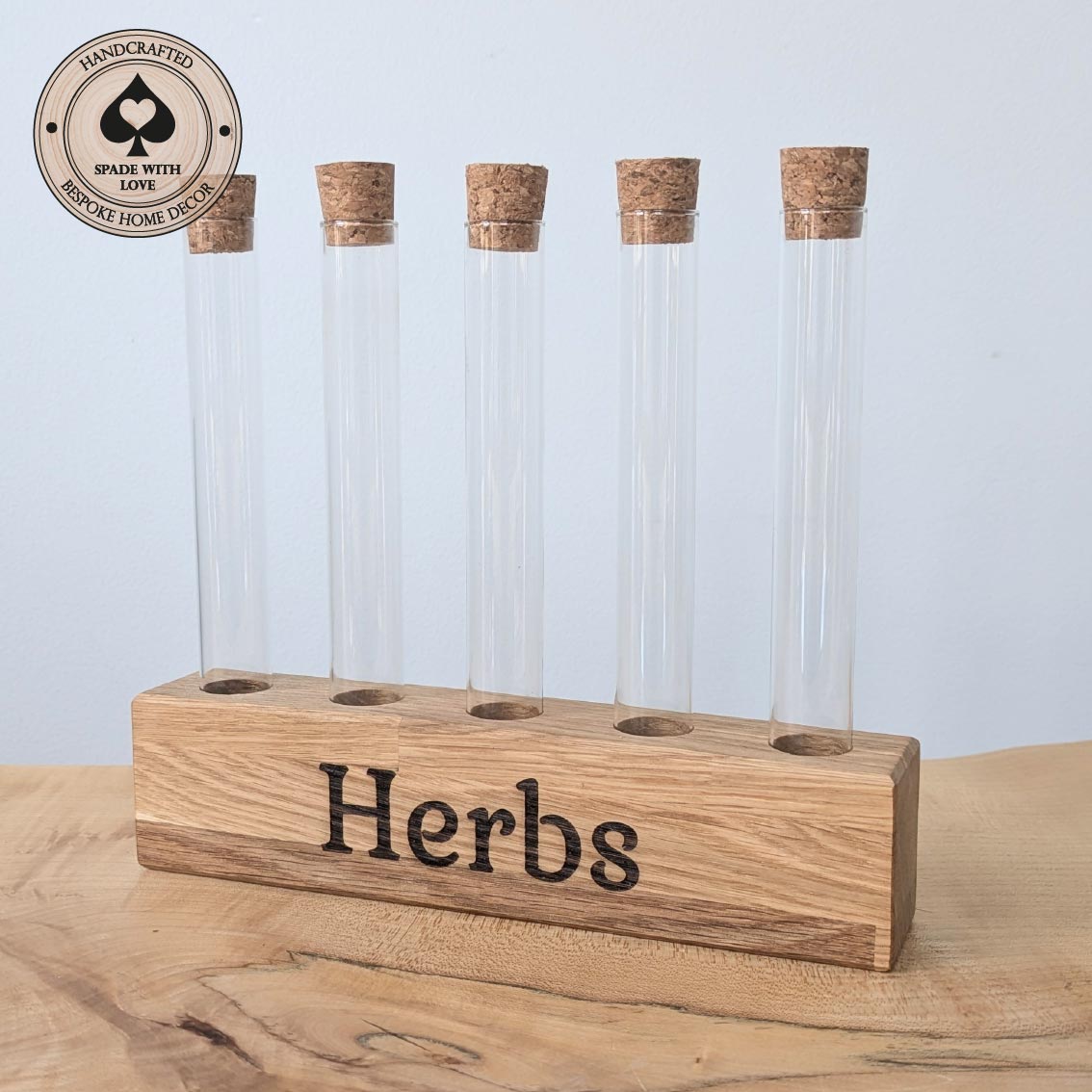 Wooden herb holder with glass tubes and cork tops on a wooden surface.