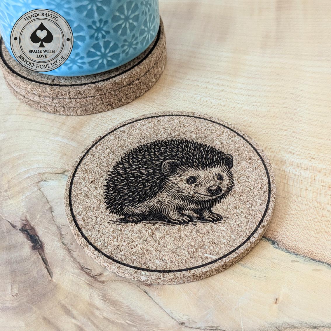 Cork coaster with hedgehog design on a wooden surface