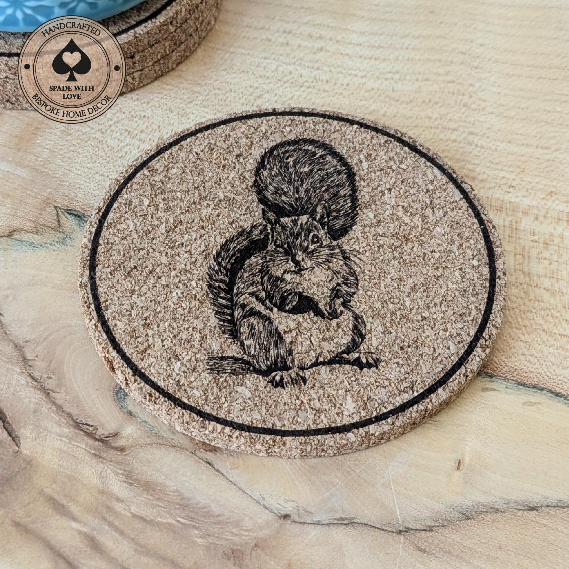 Cork coaster with a squirrel design on a marble surface